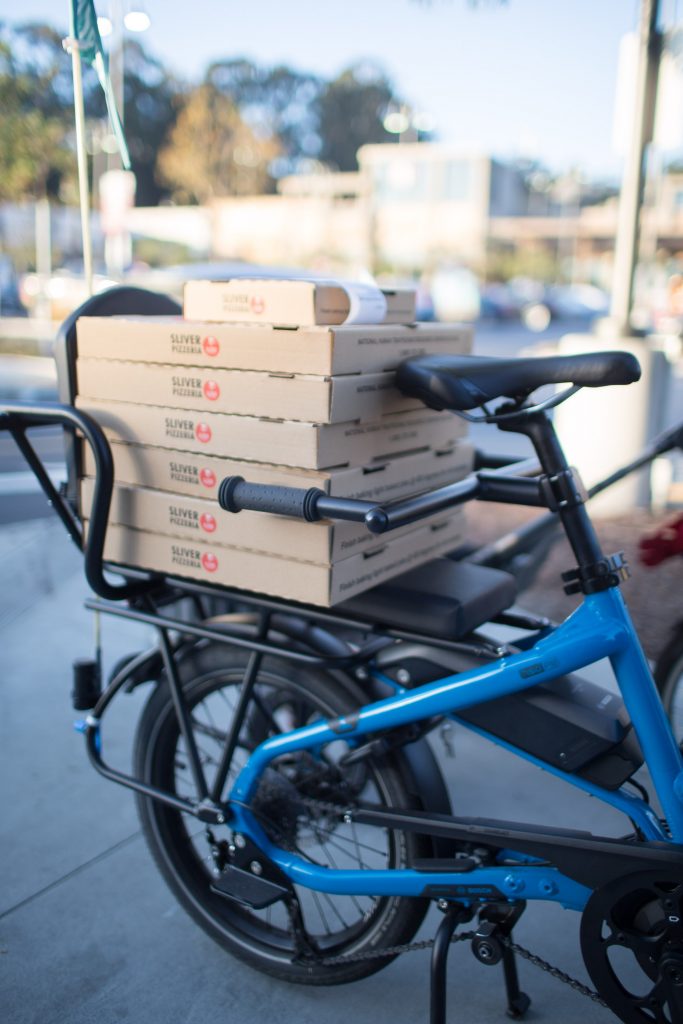 A bunch of pizzas on the back of a Tern GSD e-cargo bike