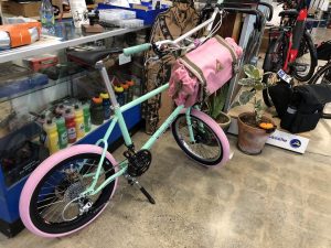 A Velo Orange MiniVelo with Pink Tires and a Pink Bag at Blue Heron Bikes in Berkeley, CA