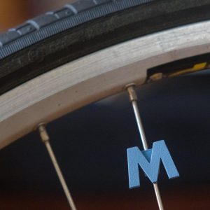 Bicycle spoke decoration in the shape of the letter M