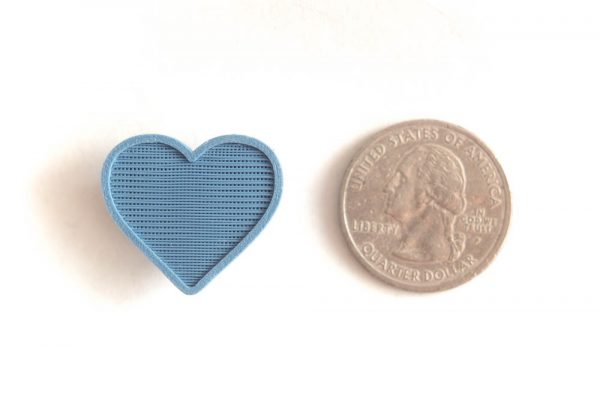 Heart spoke decoration for bicycle wheel spokes. Blue color, plant based plastic. Accessory clips on bike spokes. Made in USA