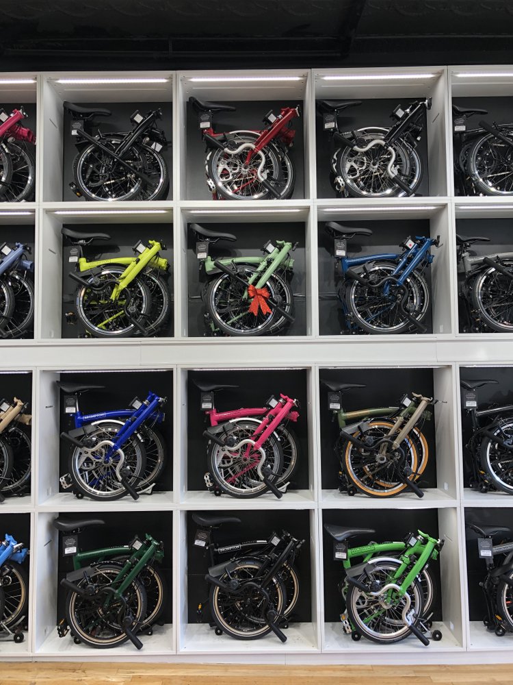 A 2-D array of Brompton Bikes, folded on a shelf
