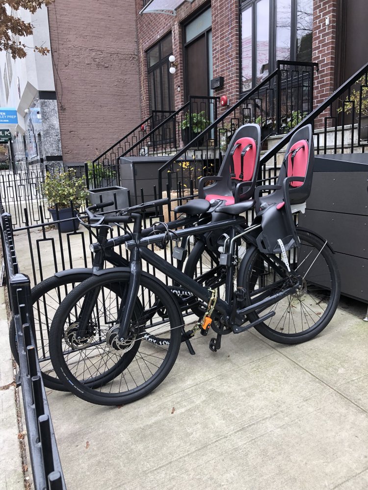 2 matching Vanmoof bikes with child seats
