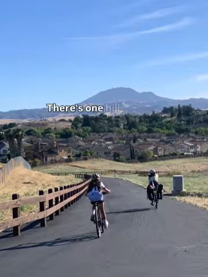 Riding home view of mount diablo with two people on bikes riding on a trail